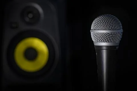 Microphone on a stand with a black background, close-up Stock Photos