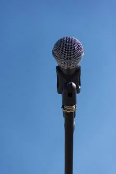 Microphone on stand on blue background Stock Photos
