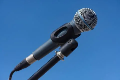 Microphone on stand on blue background Stock Photos