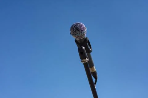 Microphone on stand on blue background Stock Photos