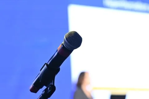Microphone on a stand with blurred lecture background, copyspace Stock Photos