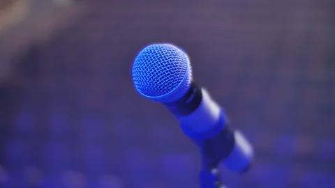 Microphone on stand close up, blurred empty theater audience. Arc shot Stock Footage 126079880
