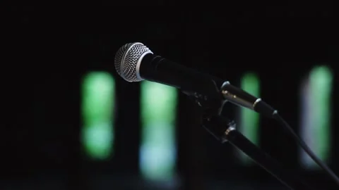 The microphone is on a stand in a dark building 스톡 동영상 132434430