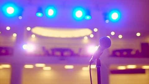Microphone on stand on stage of lights on background, close-up, Waiting for Stock Footage 105735145