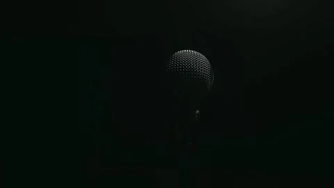 Microphone on stand waiting for performance on dark stage Stock Footage 337830588