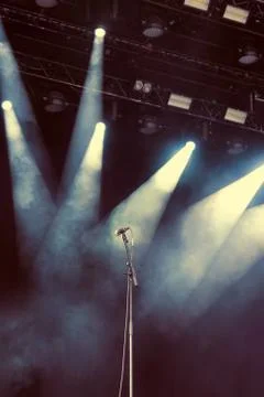 Microphone standing on the empty dark stage before concert Stock Photos