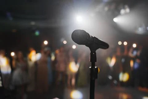 Microphone stands ready for performance at event Stock Photos