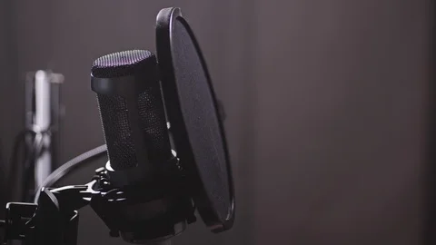 A microphone in the studio, a man appears, starts reciting or humming. 4K Slow Stock Footage 105287608
