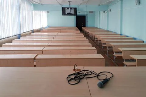 Microphone on a table in an empty classroom for lectures at the university Stock Photos