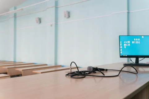 Microphone on a table in an empty classroom for lectures at the university Stock Photos