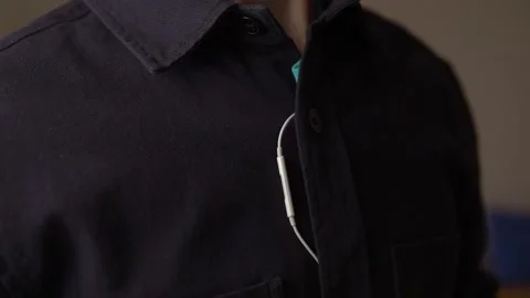 The microphone of the telephone headset with buttons is fixed on the shirt Stock Footage 238080577