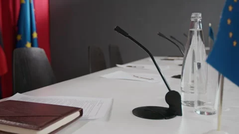 Microphones on Empty Table with European Union Flags Waiting for Summit Stock Footage 337068133