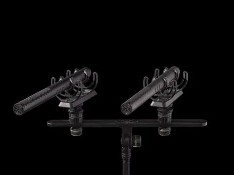 Microphones matched pair on shock mount isolated on black Stock Photos