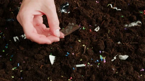 Microplastic earth pollution, plastic particles in soil close-up, cleaning Stock Footage 205892780