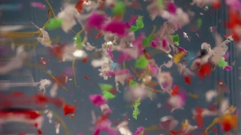 Microplastic pieces drift in water in slow motion, representing lab analysi.. Stock Footage 291869341