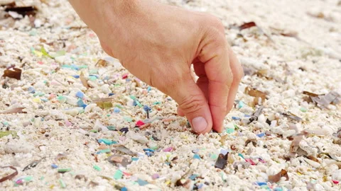 Microplastic pollution and plastic pieces on beach sand, single-use waste Stock Footage 306723837