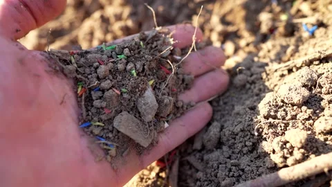 Microplastic pollution. Microplastics in ground. Stockbeeldmateriaal 278221387