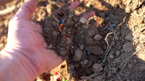 Microplastic pollution. Microplastics in ground. Stockbeeldmateriaal 278222268