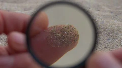 Microplastic research, colorful plastic particles in sand close up view. Taking Vidéo 243067945