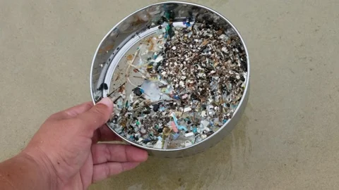 Microplastic waste contaminated with the seaside sand. Stock Footage 140981989