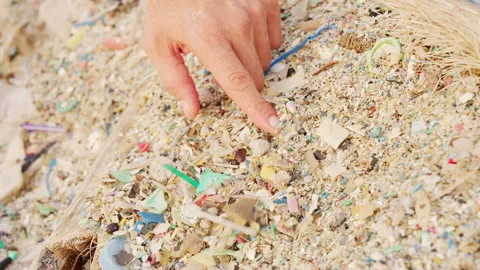 Microplastics particles in beach sand, ocean pollution, close-up Stock Footage 336489926