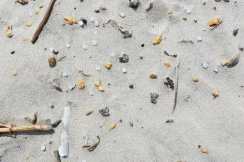 Microplastics pollution on beach, close-up Stock Photos