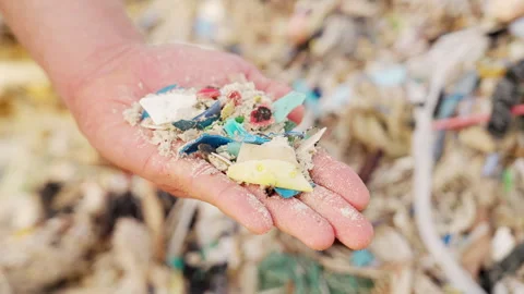 Microplastics pollution in sand on beach, plastic waste in ocean Stock Footage 336490980