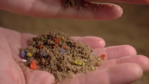 Microplastics on sandy beaches, tiny multicolored plastic bits in sand Video stock 155159301