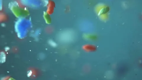 Microplastics in water, tiny multicolored plastic bits. global ocean pollution - Stock Footage 157157167