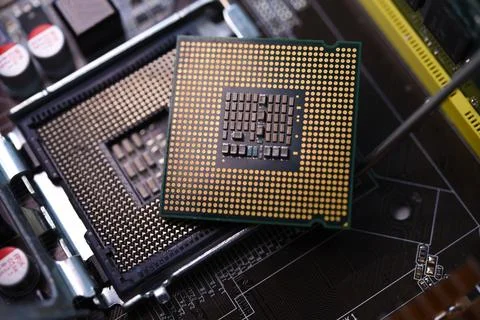 Microprocessor and socket on the motherboard. Computer radio components. Mi.. Stock Photos