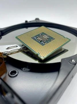 Microprocessor CPU chip on a silver hard disk plate closeup with selective fo Stockfoto's