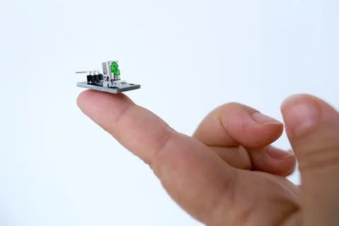 Microprocessor on finger of female hand on white background, research, deve.. Stock Photos