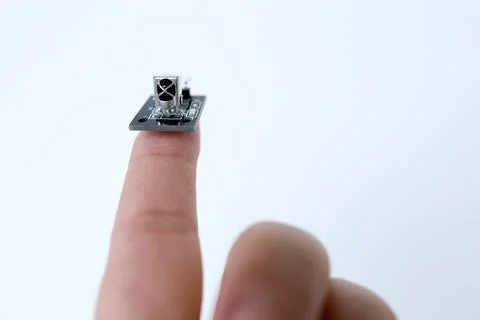 Microprocessor on finger of female hand on white background, research, deve.. Stock Photos