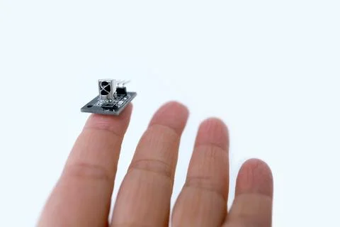 Microprocessor on finger of female hand on white background, research, deve.. Stock Photos