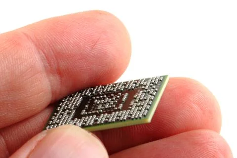 Microprocessor in human hand Stock Photos
