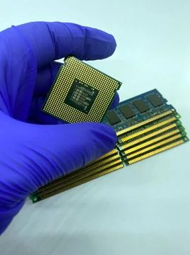 Microprocessor kept on gloved hand closeup view with a stack of RAM isolated  Foto stock