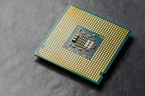 The microprocessor processor of the CPU of a computer or laptop lies on a dark Stock Photos