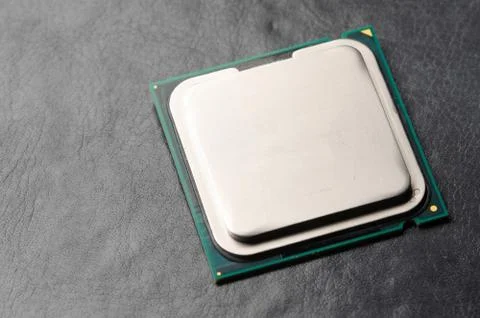 The microprocessor processor of the CPU of a computer or laptop lies on a dark Foto stock