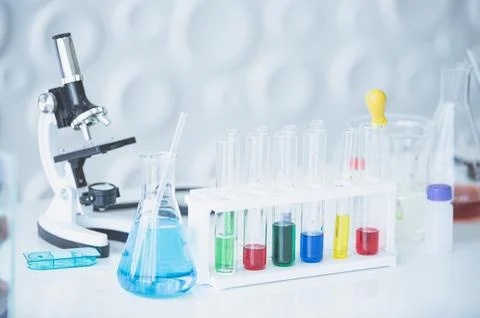 Microscope and colorful test tubes on table in Laboratory. Science chemistr.. 写真素材