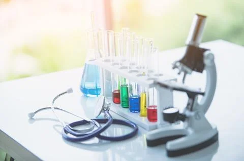 Microscope and colorful test tubes on table in Laboratory. Science chemistr.. 写真素材