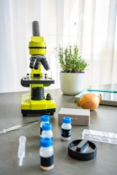 Microscope and science kit with glass slides, tweezers, and prepared chemical 写真素材