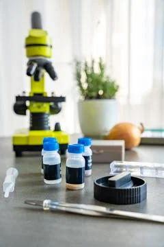 Microscope and science kit with glass slides, tweezers, and prepared chemical 写真素材