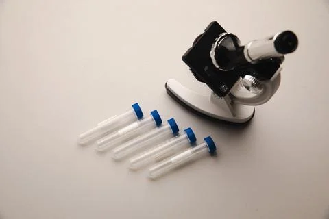 Microscope and test tube on a table. Healthcare concept Stock Photos