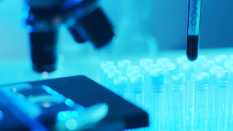 Microscope and a tube with virus. Close-up of scientific laboratory in hospital Stock Footage 127806676