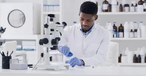 Microscope, black man and scientist in laboratory with medical research for.. Fotos de archivo