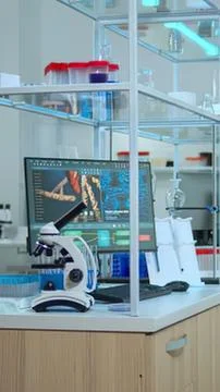Microscope with computer monitor in lab setting Stock Photos