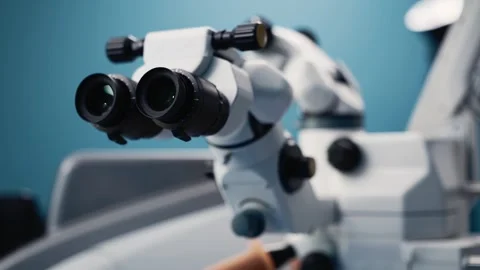 Microscope with dual eyepieces positioned for ophthalmic microsurgery, Stock Footage 337286067