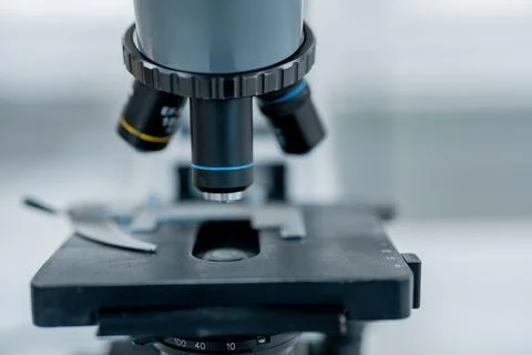 Microscope focused on a slide in a laboratory setting during a research sessi Stock Photos