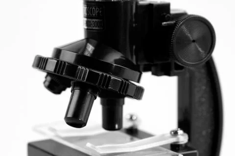Microscope in front of plain background Stock Photos