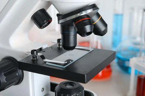 Microscope with glass slide on table, closeup. Laboratory analysis Stock Photos